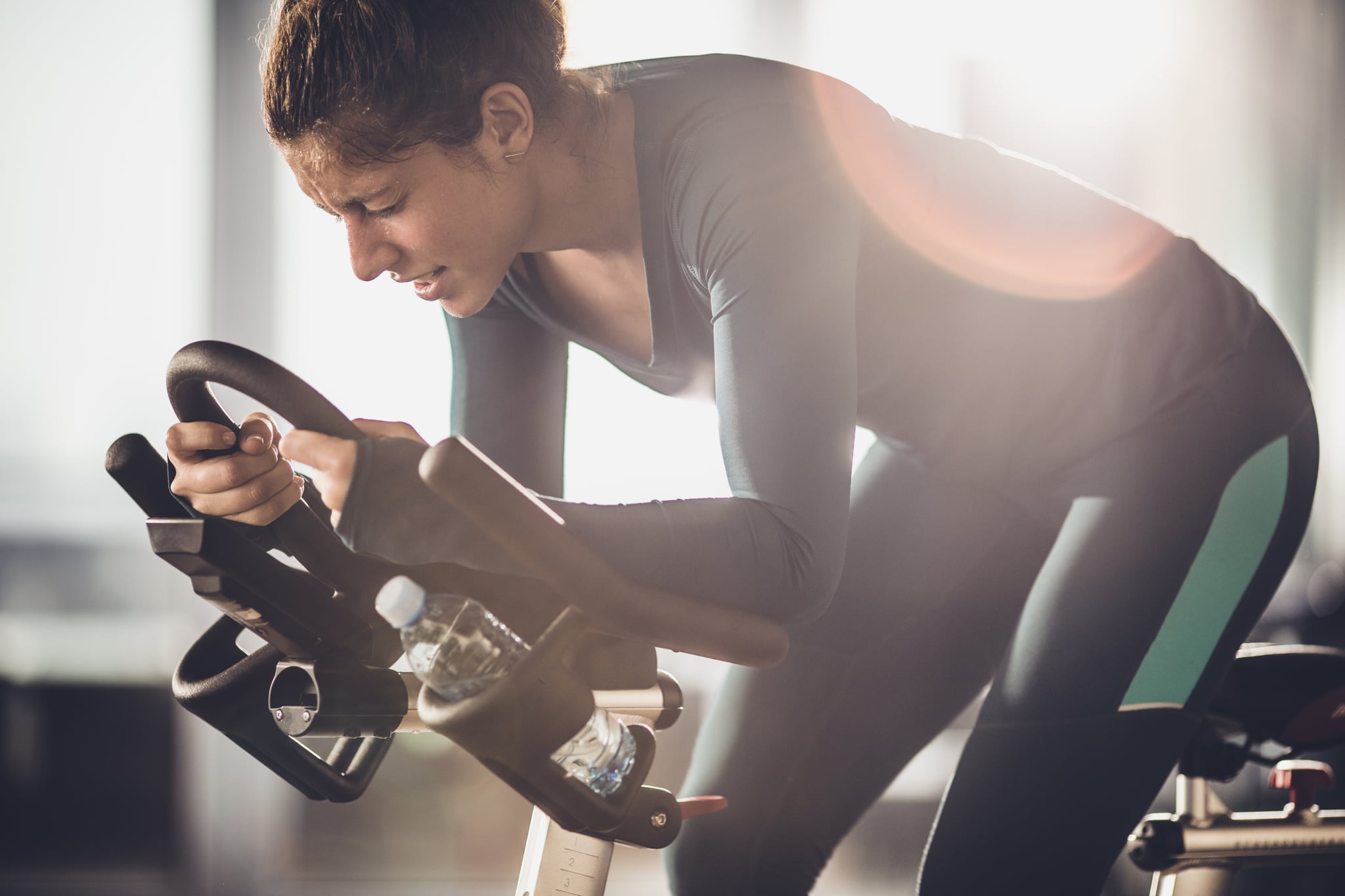 Determined female athlete making an effort on a exercising class in a health club.