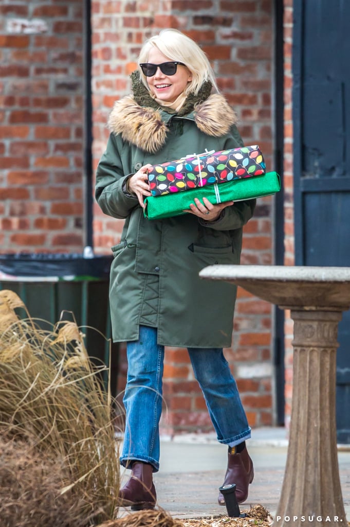 Michelle Williams carried gifts and flashed a smile in Brooklyn, NY, on Sunday.