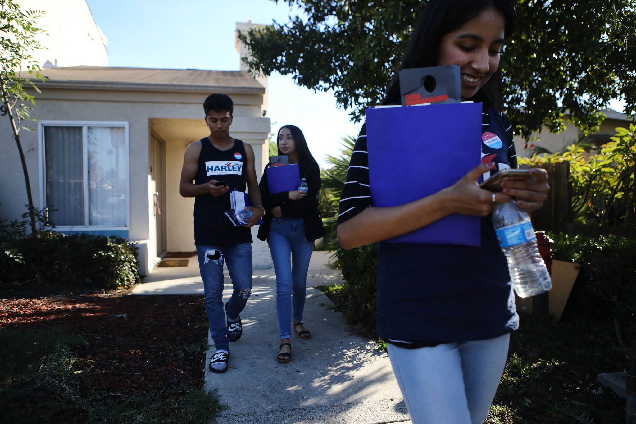 COSTA MESA, CA - OCTOBER 20:  First-generation American volunteers canvass for Democratic congressional candidate Harley Rouda (CA-48) on October 20, 2018 in Costa Mesa, California. They said they are canvassing because their parents are not allowed to vote in the election due to lack of citizenship. Rouda is competing for the seat against Republican incumbent Rep. Dana Rohrabacher. Democrats are targeting seven congressional seats in California, currently held by Republicans, where Hillary Clinton won in the 2016 presidential election. These districts have become the centerpiece of their strategy to flip the House and represent nearly one-third of the 23 seats needed for the Democrats to take control of the chamber in the November 6 mid term elections.  (Photo by Mario Tama/Getty Images)