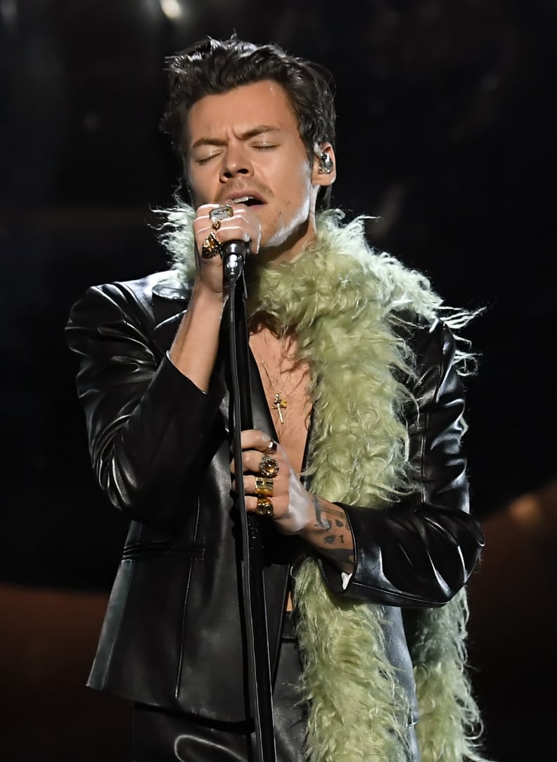 Harry Styles looks casual in a black padded jacket and matching