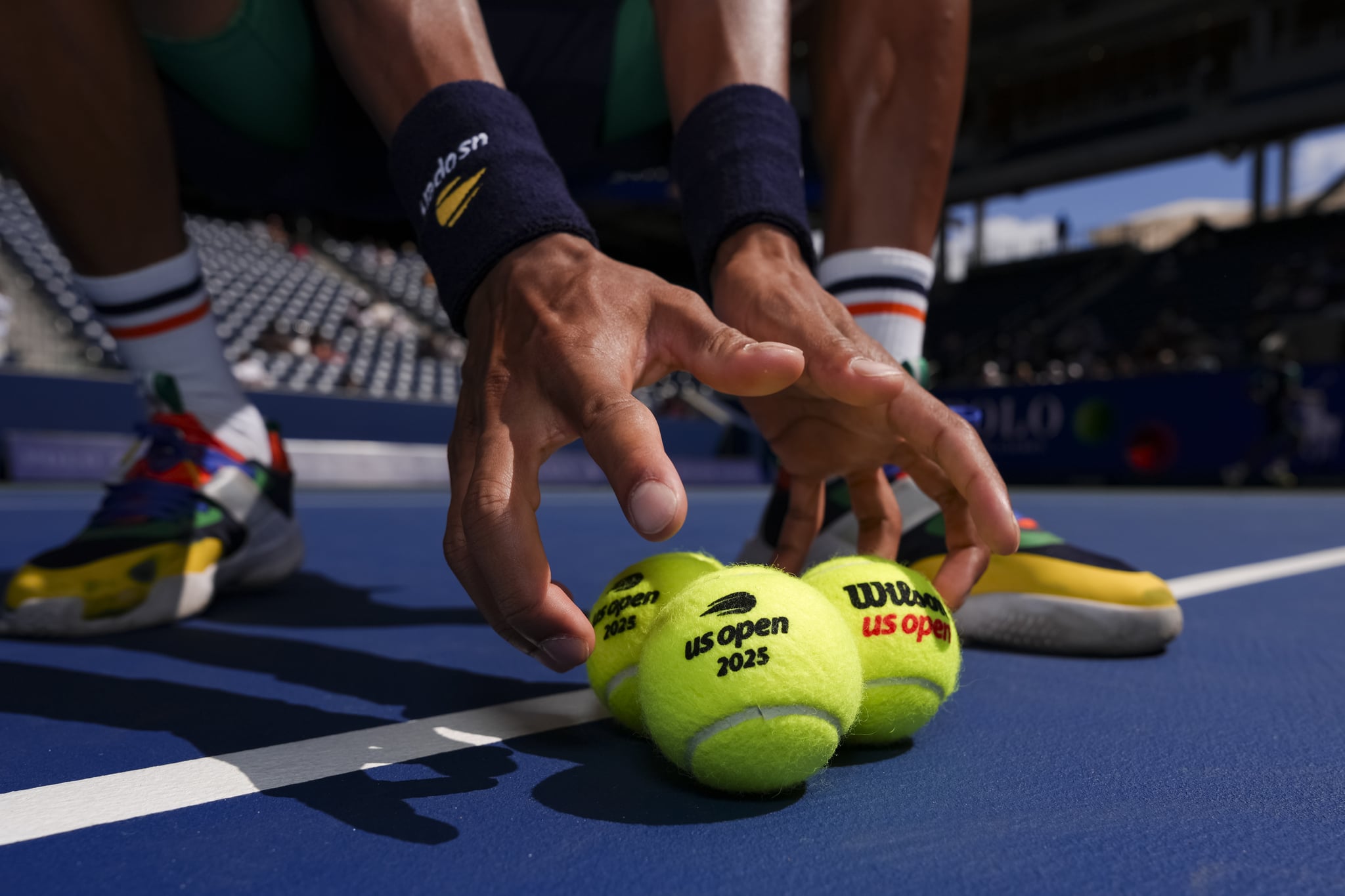 NEW YORK, NEW YORK - SEPTEMBER 04: Ball crew picks up tennis balls before a junior boys' singles quarterfinal match at the USTA Billie Jean King National Tennis Center on Thursday, September 4, 2025 in Flushing, New York. (Darren Carroll/USTA via Getty Images)
