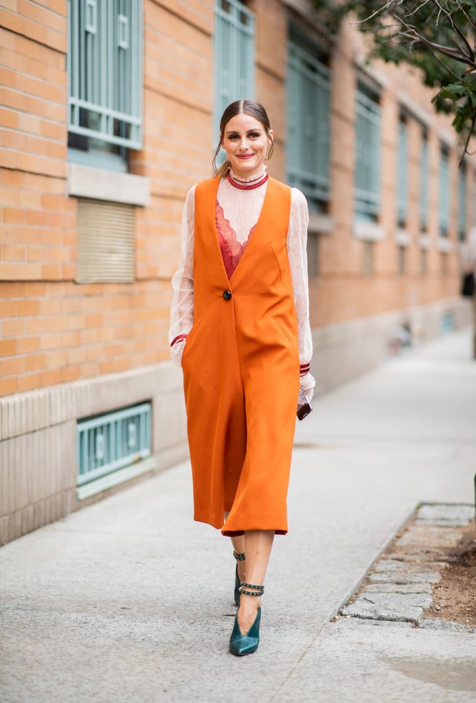 While running around NYC, Olivia was a bright spot in an orange vest and emerald pumps.