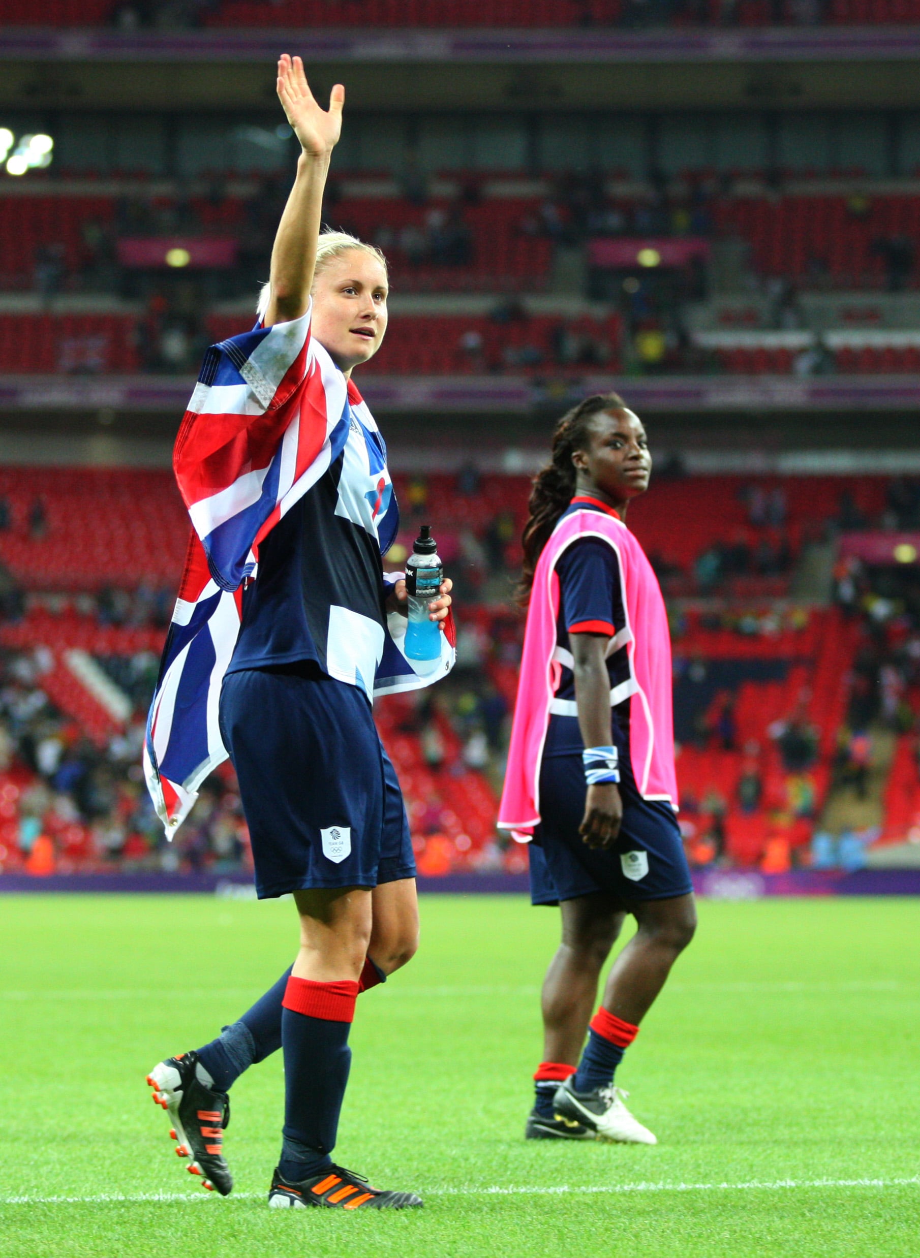 Stephanie Houghton of Team GB Women waves to the fans at the end of the match wearing a Union Jack flag during the 2012 London Olympic Summer Games at Wembley Stadium, London, England, UK on July 31st 2012 (Photo by AMA/Corbis via Getty Images)