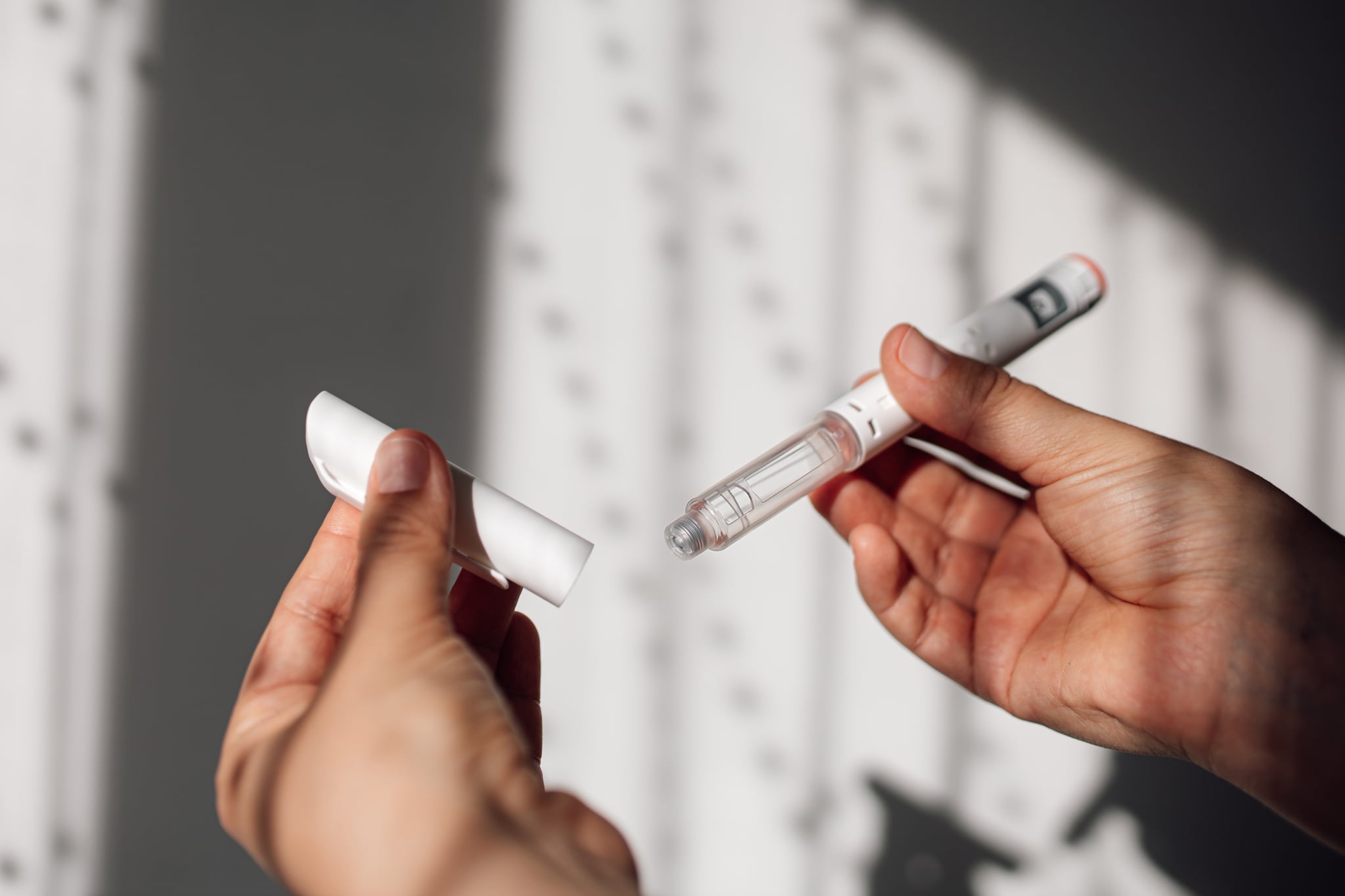 Semaglutide injection pen or cartridge pen held in female hand. 