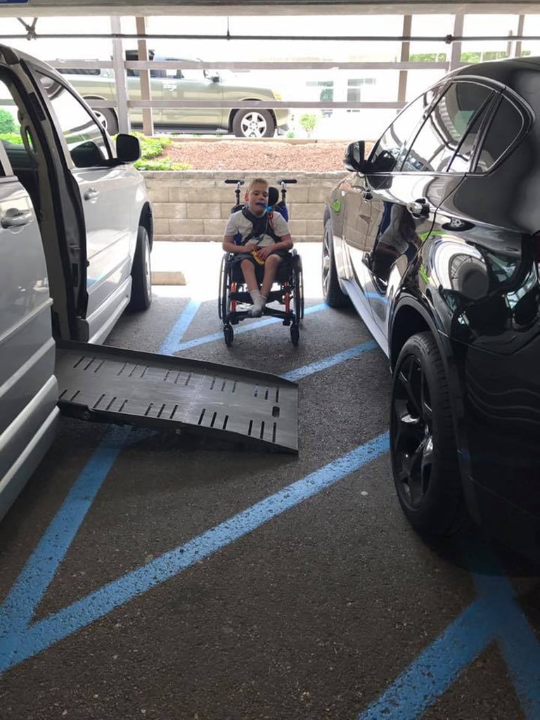 Boy's Wheelchair Ramp Blocked by Car Parked on Blue Lines