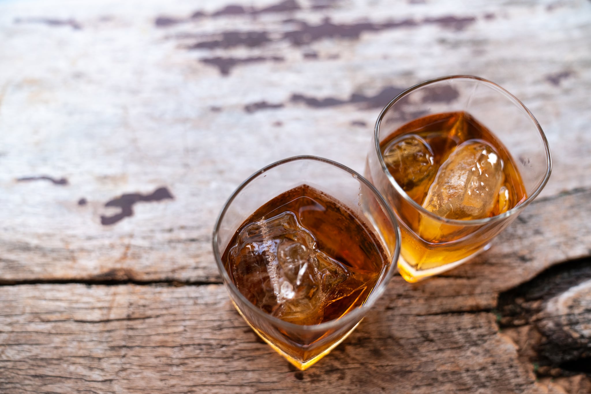 Two rye whiskey cocktail drinks toasted together,Addictive substance