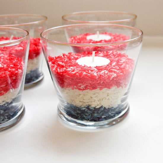 Now add the white rice to the glasses, and then add the red, leaving about two to three inches of space at the top of the votives. Place a tea light in the center of the red layer, and you're ready to party.