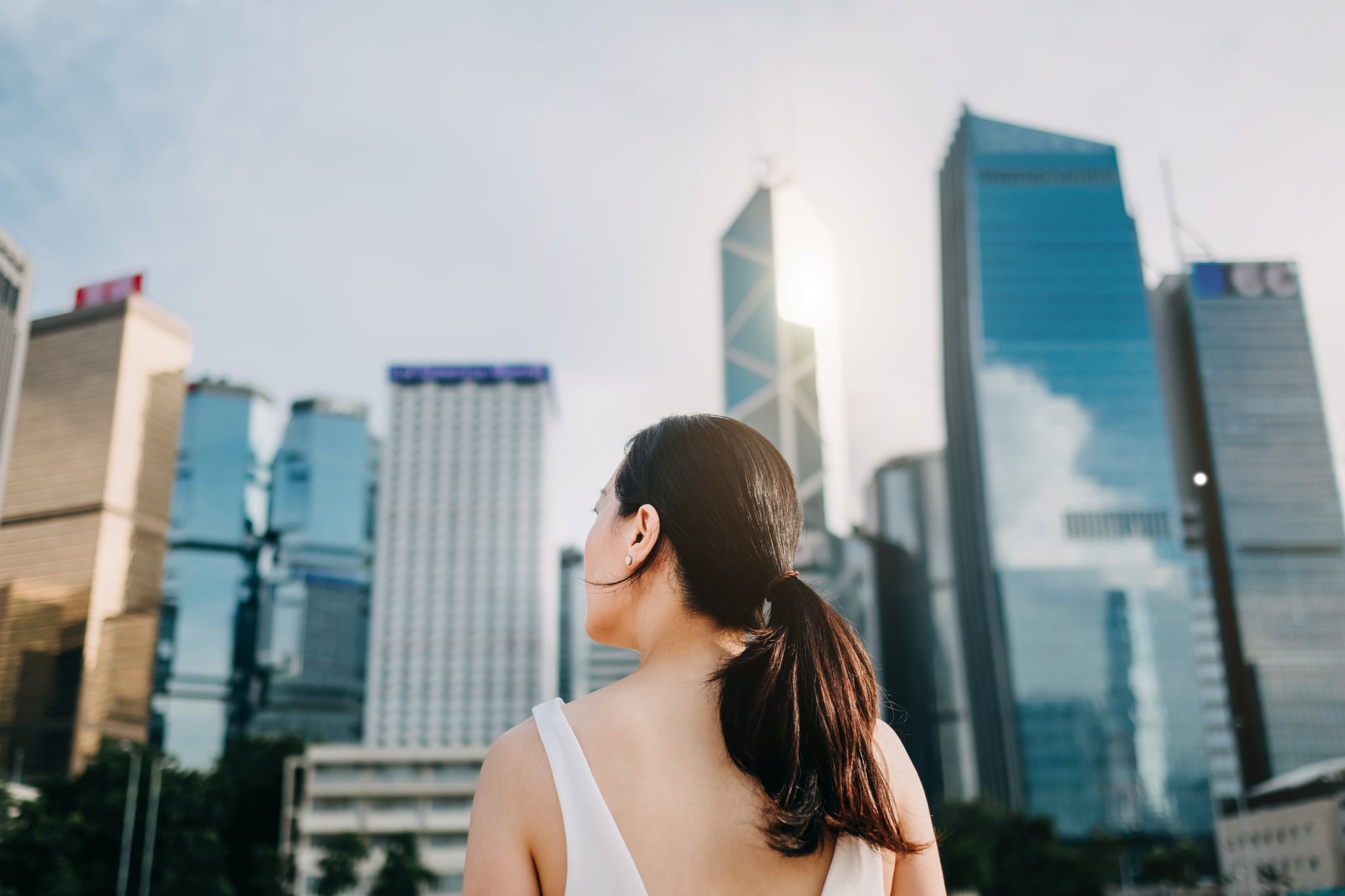 Rear view of ambitious businesswoman looking towards the urban financial towers in Central Business District