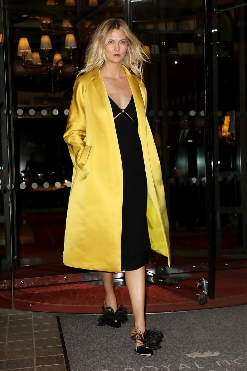 Karlie Kloss Wore a Yellow Satin Duster Coat Over a Black Midi Dress in Paris