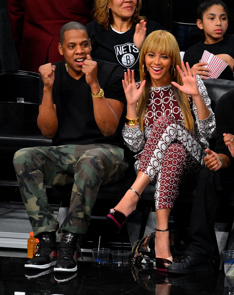 Beyoncé and Jay Z threw their hands up while checking out a Brooklyn Nets game together in November 2012.