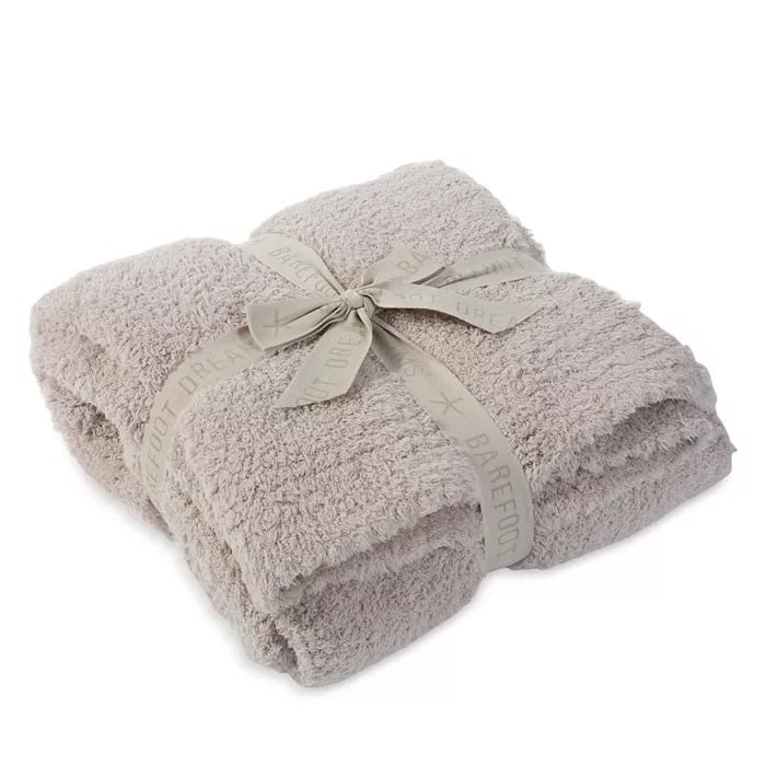 BAREFOOT DREAMS CozyChic Throw ($147)
Prep your loved one for the chilly months ahead with this luxurious throw. Available in a range of calming, neutral hues, it'll match any living room aesthetic. The best part: it's machine-washable, which is pivotal if the kids or puppies want to get in on the snuggle.