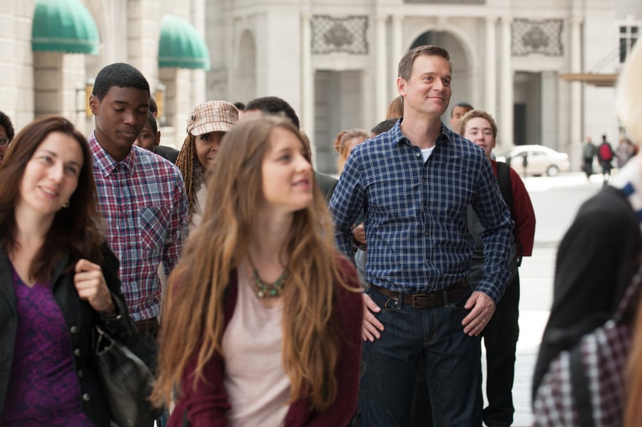 Adam (Peter Krause) stands in the crowd.