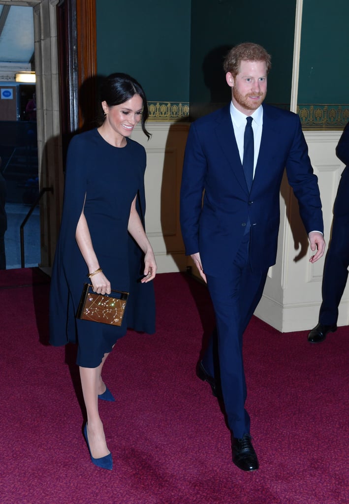 In April 2018, Meghan wore this simply stunning Stella McCartney cape dress with a Naeem Khan zodiac clutch, Isabel Marant hoop earrings, and suede Manolo Blahnik pumps for a concert at Royal Albert Hall to celebrate the queen's 92nd birthday in London.