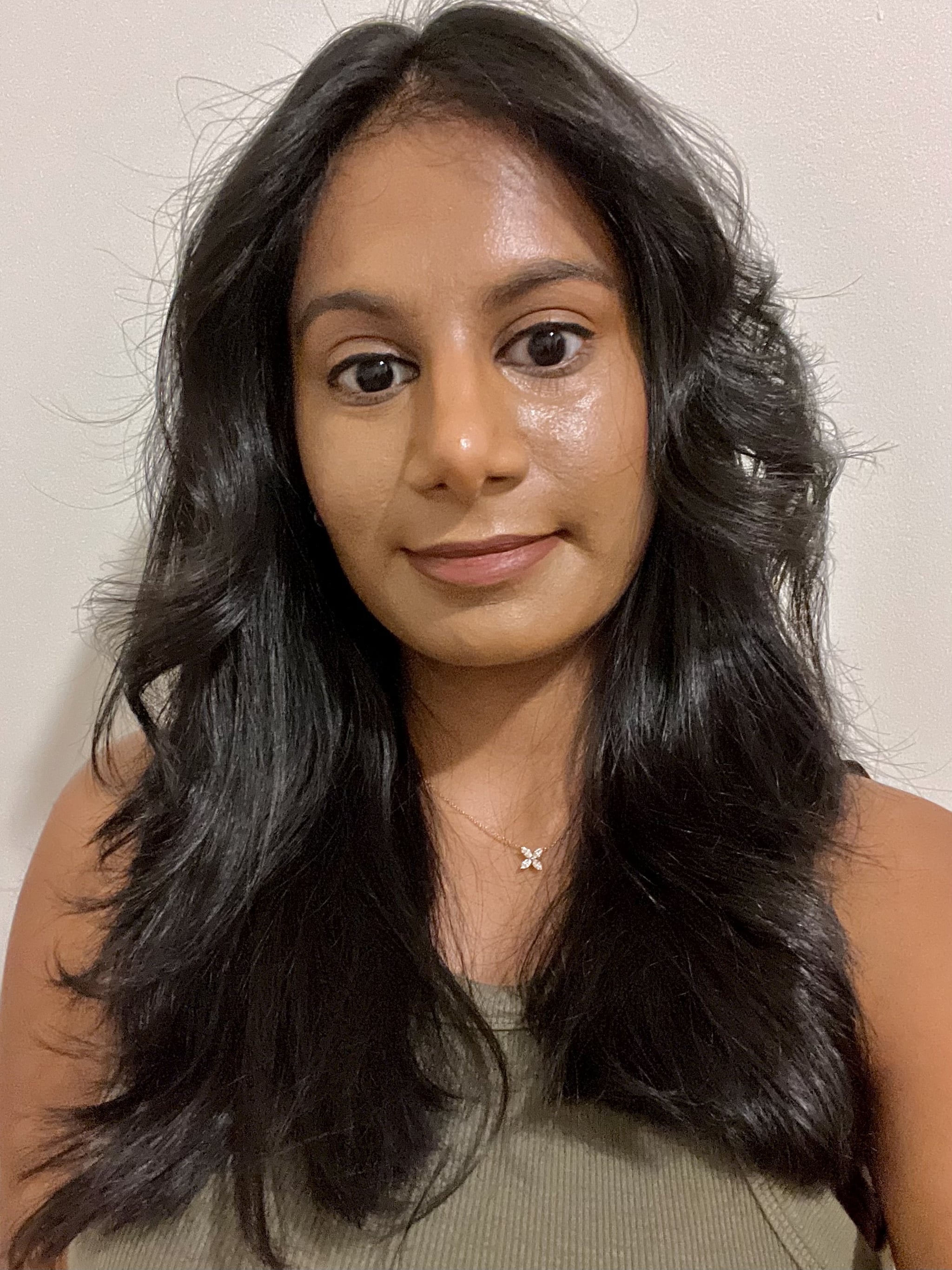 Woman showing her hair after using the Ranavat Regenerative Veda⁴ Bond Complex Shampoo and Conditioner.