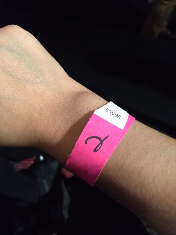 After a few minutes, men came around with bracelets. I stuck my arm out, gave dirty looks to the people pushing me from behind, and silently prayed I wouldn't get trampled. Finally, I felt one tighten around my wrist and together, the mass made its way into the "store." (I still have no idea what the number means.)