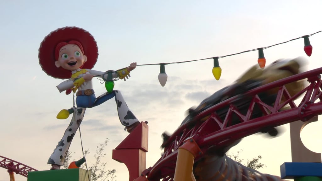 Jessie holding up string lights in the middle of Slinky Dog Dash.