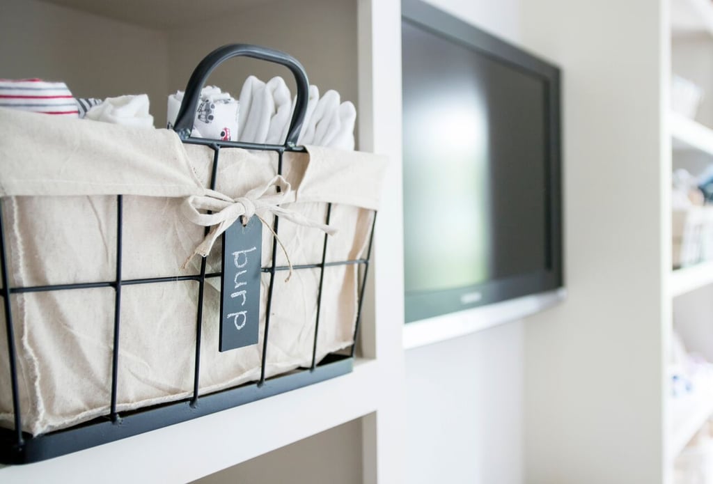 A television is front and center in the open shelving unit.