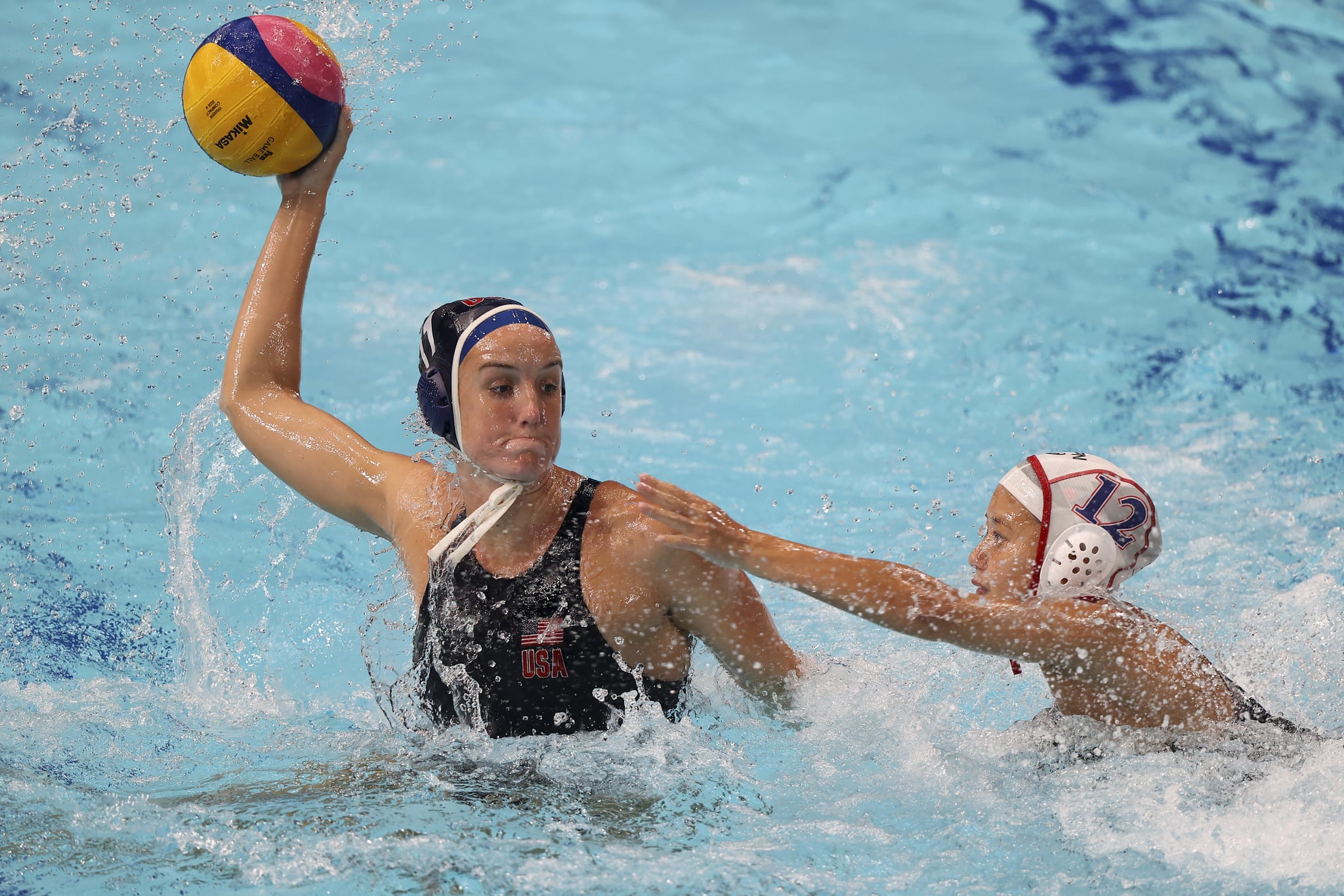 TOKYO, JAPAN - JULY 24: Kyoko Kudo of Team Japan defends against Makenzie Fischer of Team United States during the Women's Preliminary Round Group B match between Japan and the United States on day one of the Tokyo 2020 Olympic Games at Tatsumi Water Polo Centre on July 24, 2021 in Tokyo, Japan. (Photo by Clive Rose/Getty Images)