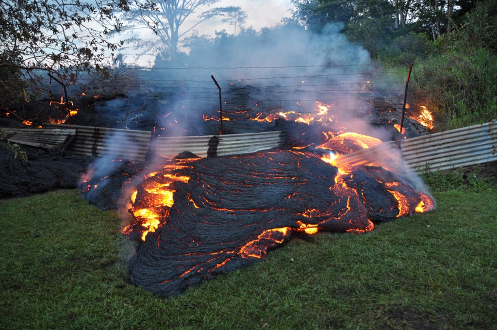 Lava flowed through a fence in Pahoa, Hawaii, from the Kilauea Volcano.