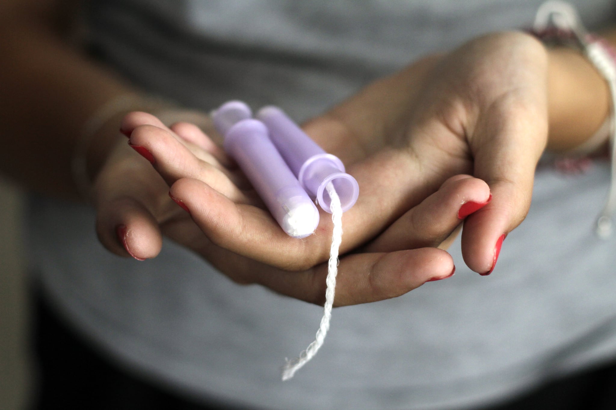 Close-Up Of Woman Hand Holding Tampons