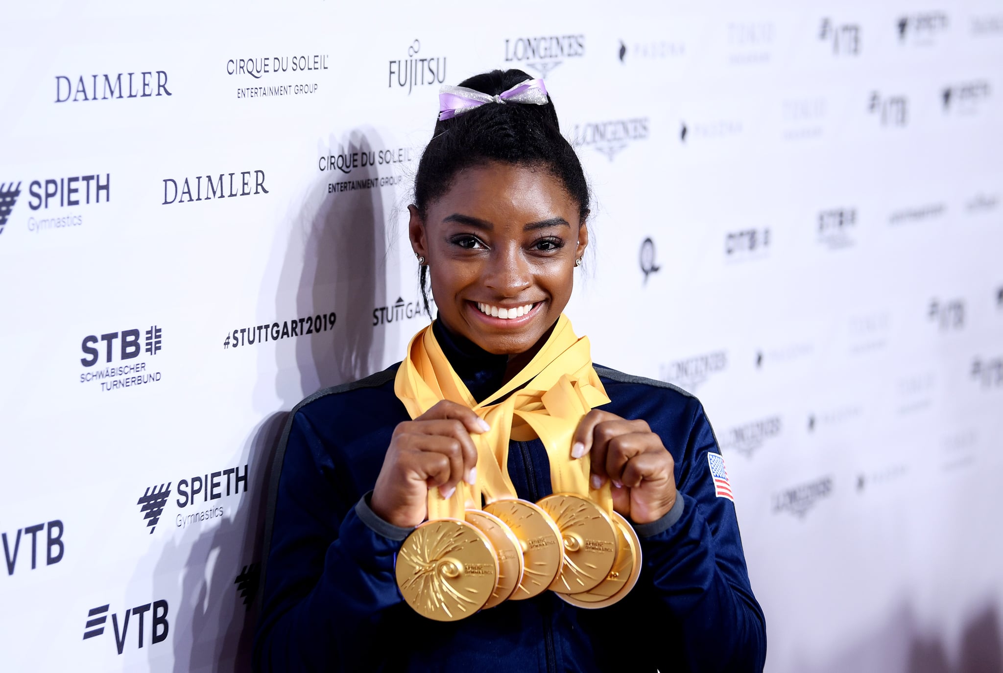 STUTTGART, GERMANY - OCTOBER 13: Simone Biles of The United States poses for photos with her multiple gold medals during day 10 of the 49th FIG Artistic Gymnastics World Championships at Hanns-Martin-Schleyer-Halle on October 13, 2019 in Stuttgart, Germany. (Photo by Laurence Griffiths/Getty Images)