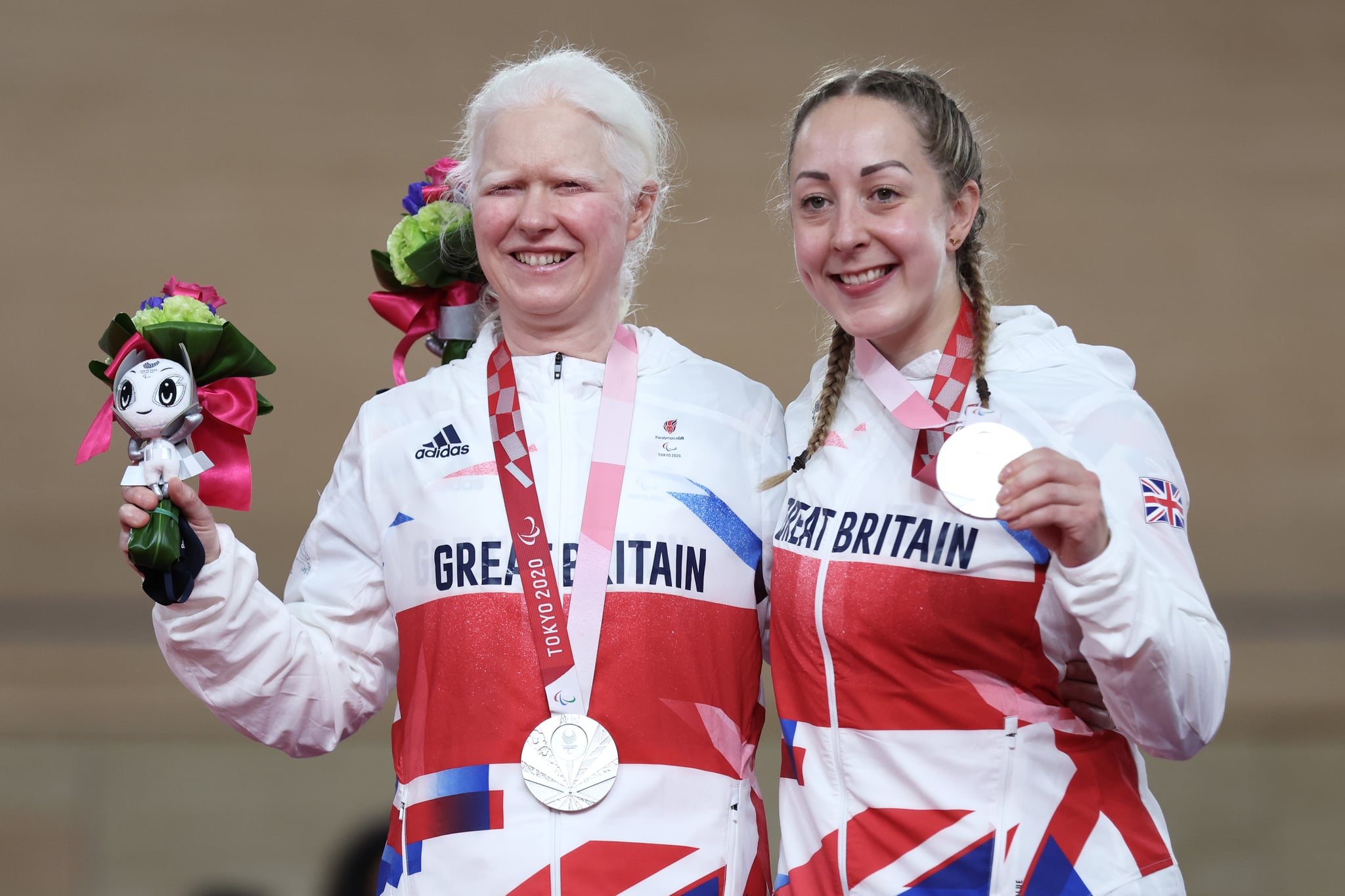 IZU, JAPAN - AUGUST 26: Silver medalists Aileen McGlynn (L) and pilot Helen Scott of Team Great Britain celebrate on the podium during the medal ceremony for the Track Cycling Women's B 1000m Time Trial on day 2 of the Tokyo 2020 Paralympic Games at Izu Velodrome on August 26, 2021 in Izu, Shizuoka, Japan. (Photo by Kiyoshi Ota/Getty Images)