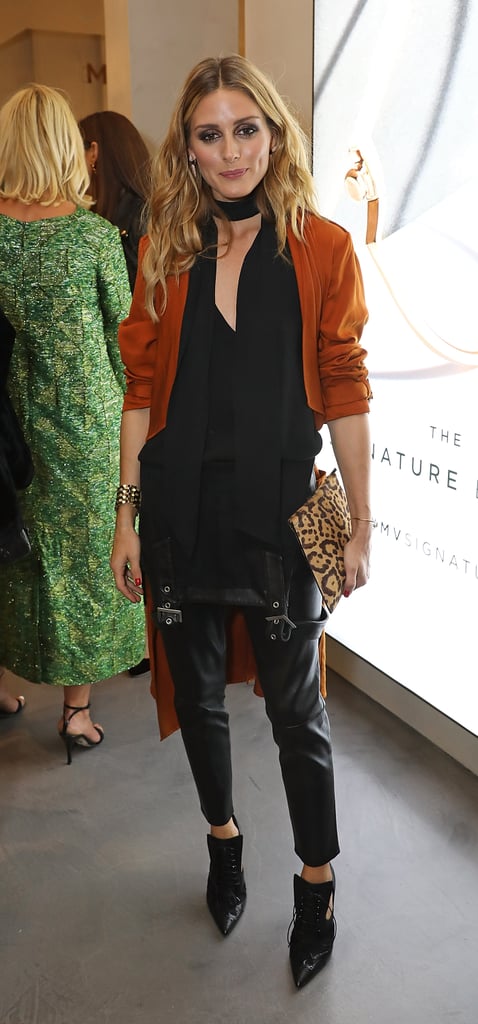 At a London Fashion Week dinner, the style setter peeled her overalls down to her waist and topped the look with a black blouse and skinny scarf. How's that for innovative?