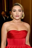 Florence Pugh Is Bringing the Peplum Back in a Red Corseted Gown and Puss in Boots Hat