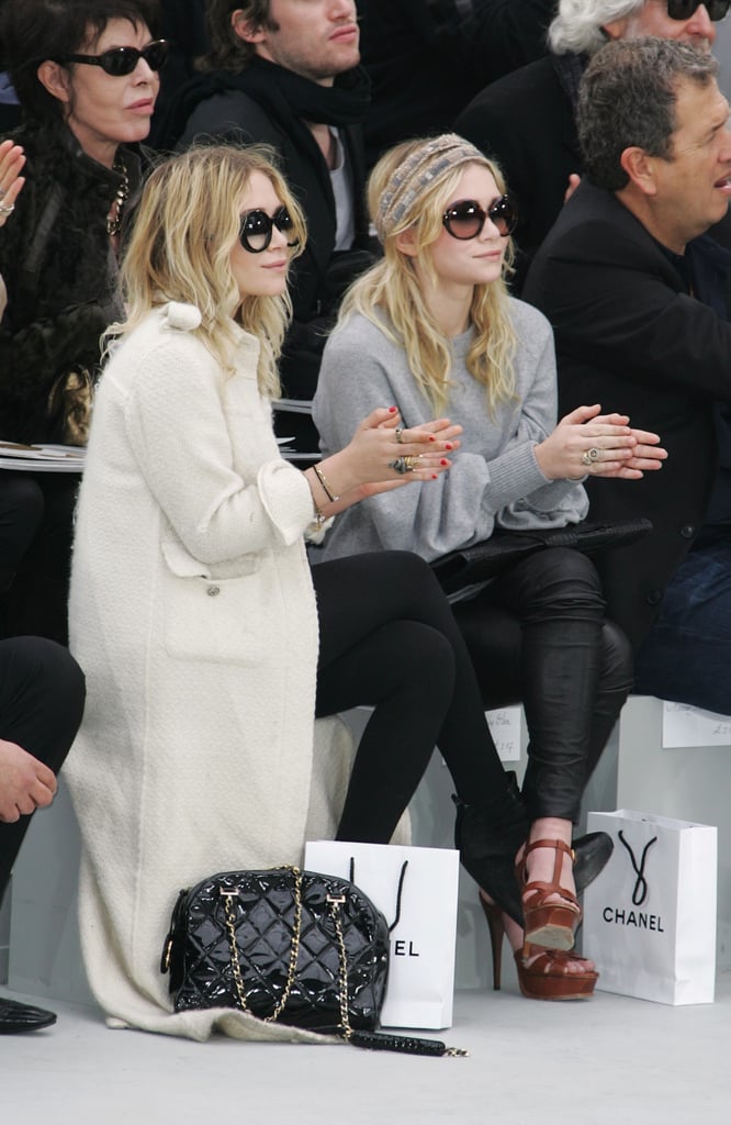 Twinning combo: The girls took in the Chanel Fall/Winter 2008 show with killer eyewear.

Ashley paired a long, white tweed coat with black ankle boots, a quilted bag, and oversize shades.
Mary-Kate went sporty in a gray sweater, black leather leggings, and YSL platforms and a printed headscarf.
