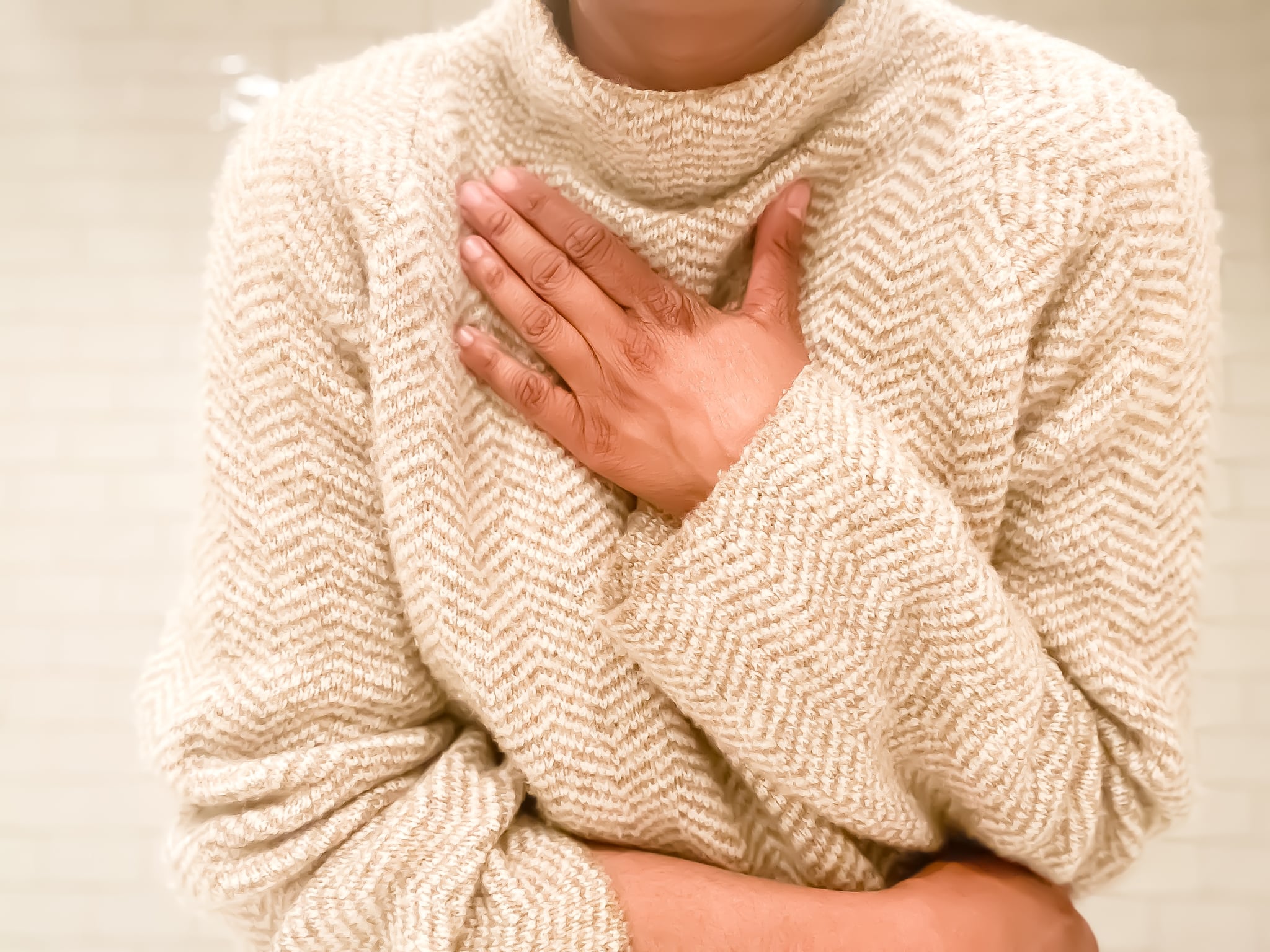 mid adult woman experiences symptom of shortness of breath