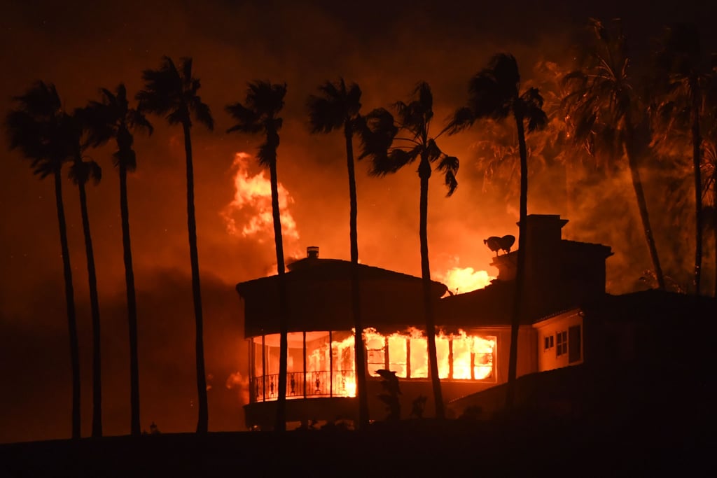 A Malibu home is engulfed in flames during Woolsey Fire.
