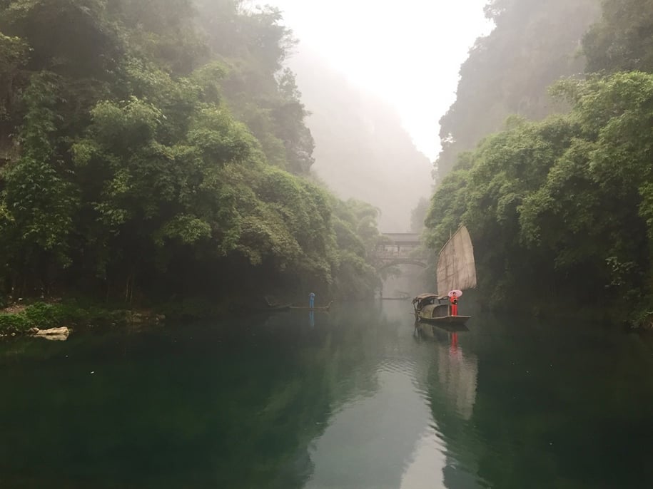 "Finding a perspective with natural sight lines can help highlight the details in a photo. Here, the walls of the valley guide your eye toward the two bold pops of red and blue on the water."