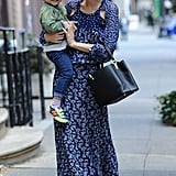 Miranda took Flynn (and her Capucines bag!) out again for a spin, this time in a blue printed maxi dress and sandals.