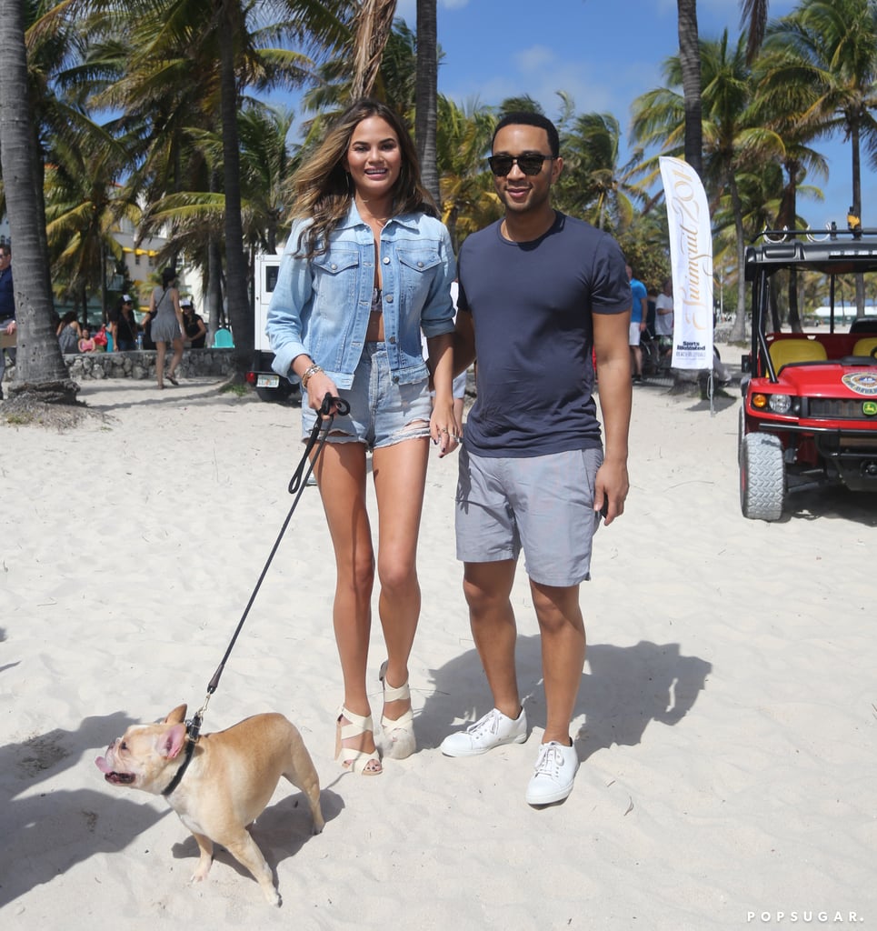 Chrissy Teigen and John Legend took their dog for a walk on the beach in Miami on Thursday.