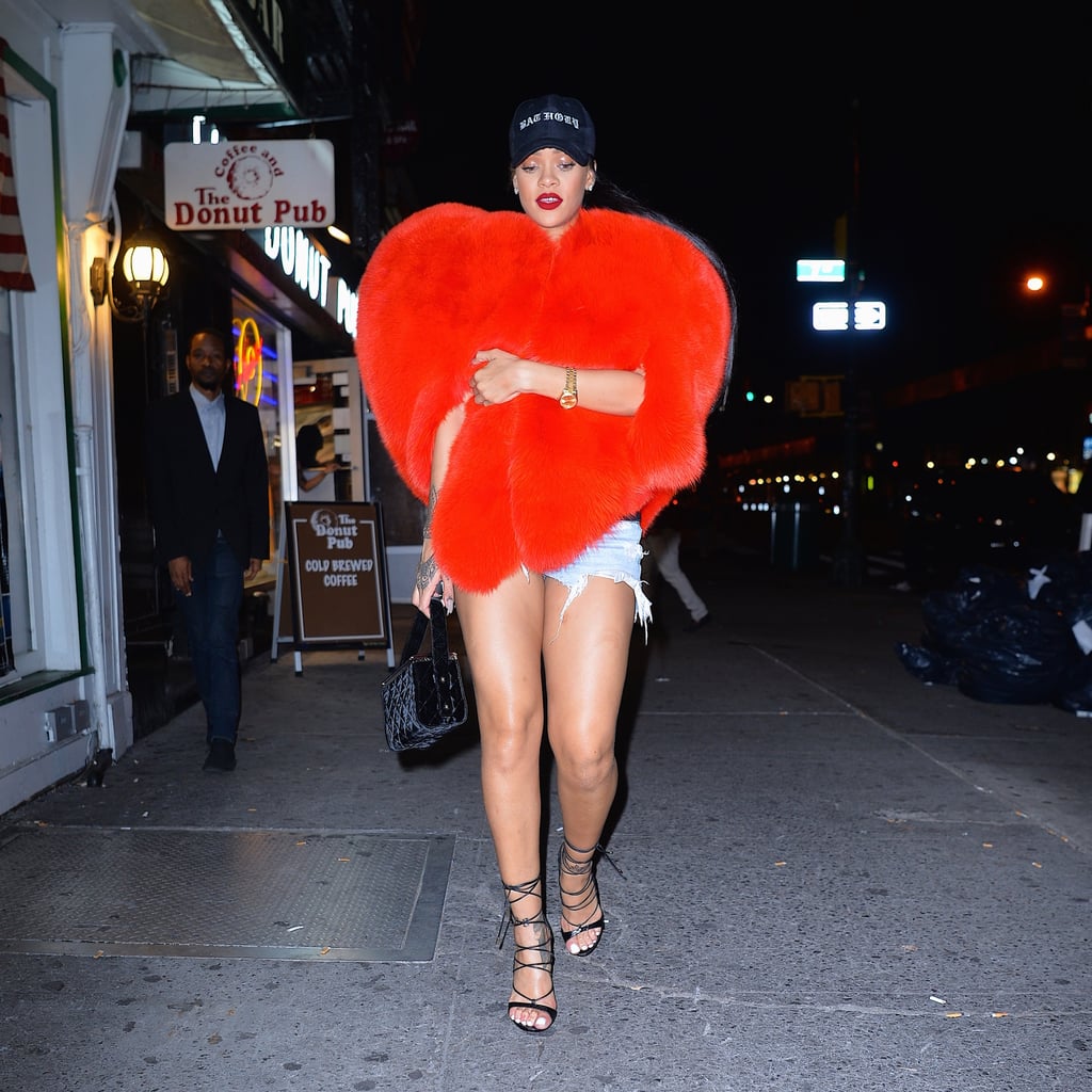 Rihanna styled the piece with cooler, casual add-ons, like cutoffs, lace-up heels, and a baseball cap to top off the whole thing.