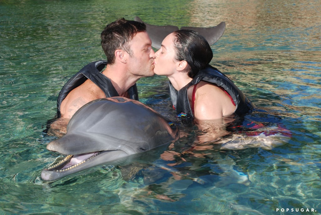 The couple shared a cute kiss as they swam with dolphins in Hawaii during their honeymoon in June 2010.