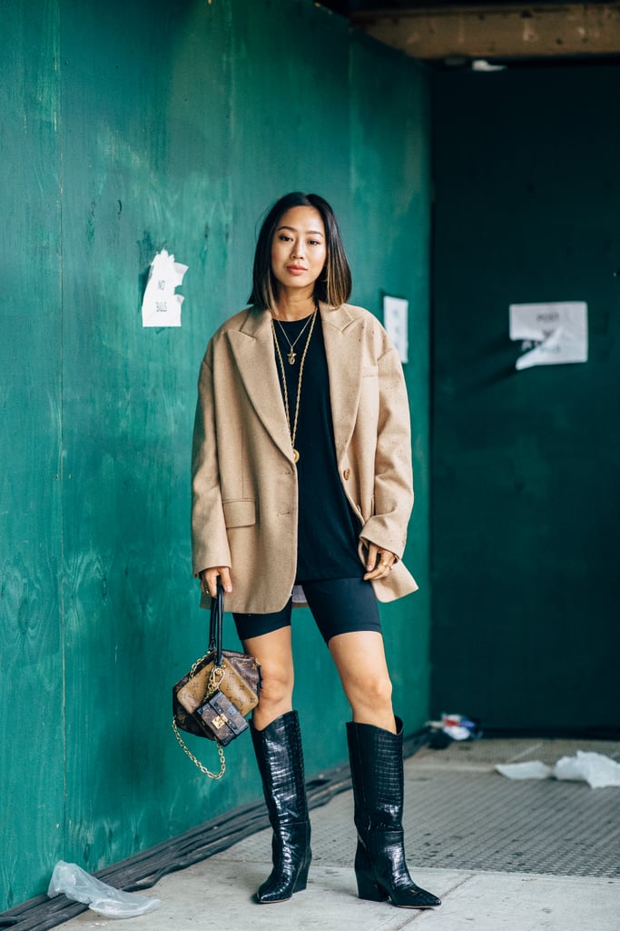 Aimee Song with a Louis Vuitton bag and Tibi boots.