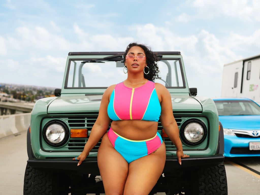 For those seeking more understated options, consider the simple black one-piece with mesh detailing or the gold-and-black ribbed cutout one-piece, which Majors reveals is among her favorites.
"I used to immediately say the colorblock two-piece was my favorite — it still is definitely in my top three — but there's the black glitter cutout one-piece," she says. "That's a sleeper. I wore it the other day, and I was taken aback by how much I liked it because I really don't own black swimsuits. It covers enough but still gives you a little something with the cutout."
Majors's collection also includes several pool-ready cover-ups, ranging from a sleek side-slit little black dress to a bright-pink lace crop-top-and-pant set. In practice, she argues, cover-ups should be "as transitional as they can be." 
"Some of the pieces you could just wear alone by themselves, but a lot of them are interchangeable with the collection as well," she says. "The color palette can be transitioned with a lot of the other swim pieces. Because I know not everybody wants to wear slinky bikinis, which is totally fine. I don't always want to wear that either, so that's why I like to offer options and make people feel comfortable and confident in what they're wearing."