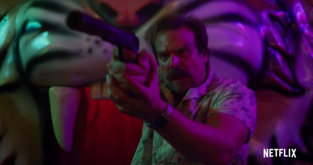 And who is the assassin hunting? Hopper, it seems. Regardless of if they strike up a romance or not, things are definitely going to get intense between Hopper and Joyce in season three, since there's a scene of Hopper practically dragging her behind him as they sprint through the Fun Fair away from the gun-toting killer. On the bright side, it seems Hopper is able to wrestle the guy's gun away from him somehow. Will he pull the trigger?