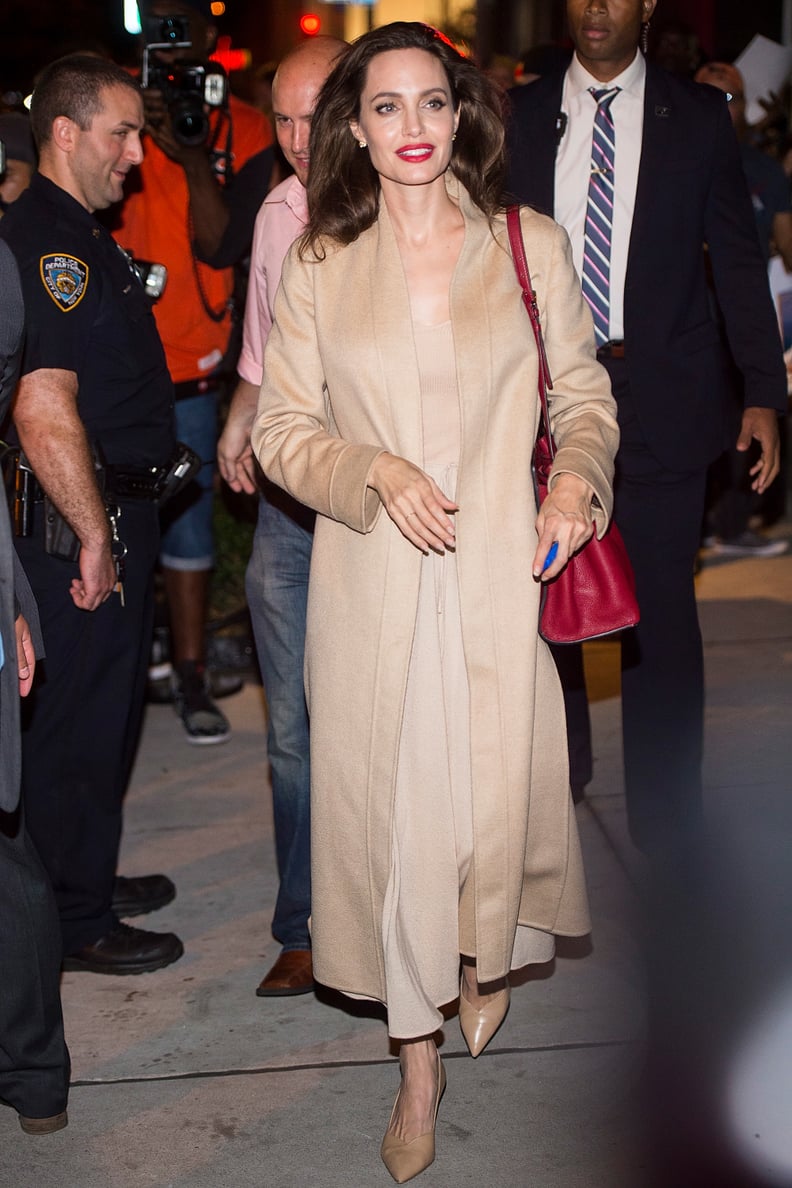 Angelina Wearing the Pumps With a Neutral Trench Coat and Valentino Bag