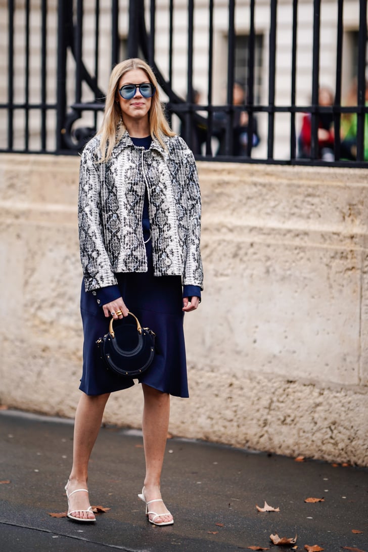Style your minimalist sandals with a snakeskin-print jacket and navy dress.