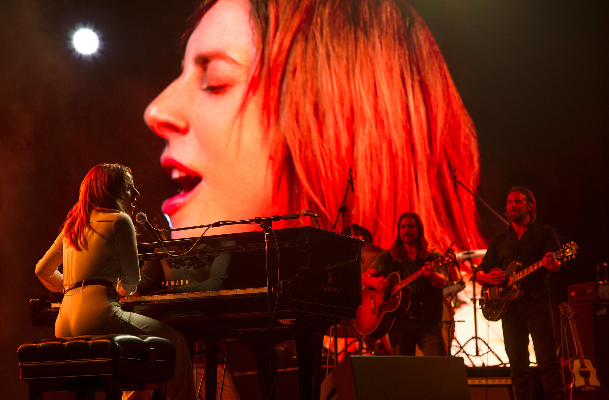 A STAR IS BORN, left and on screen: Lady Gaga, far right: Bradley Cooper, 2018. ph: Neal Preston/ Warner Bros./courtesy Everett Collection