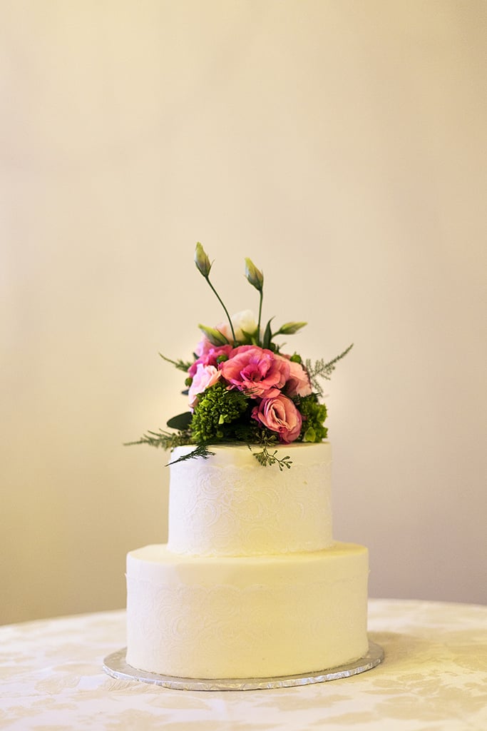Spray rosebuds and green hydrangeas heighten this cake an extra tier.