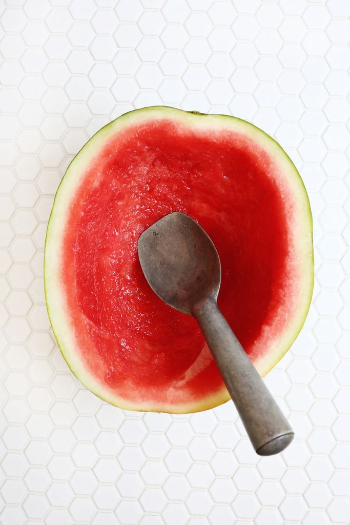 Use a large spoon or ice cream scoop to scoop out the inside of the watermelon and set aside (to later eat, of course!). You want to scoop out most of the red flesh but still leave about 1/2" of the red part above the white rind. Place the hollowed out watermelon on a cookie sheet with paper towels folded/stuffed on either side to keep it from tipping over.