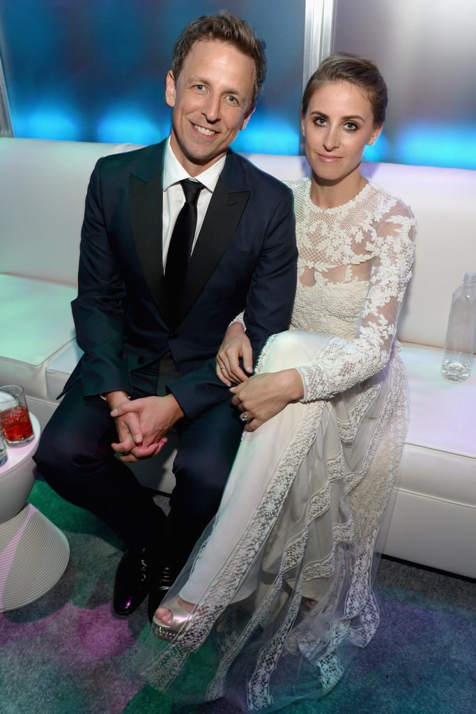 Seth Meyers and Alexi Ashe sat on a white couch.
