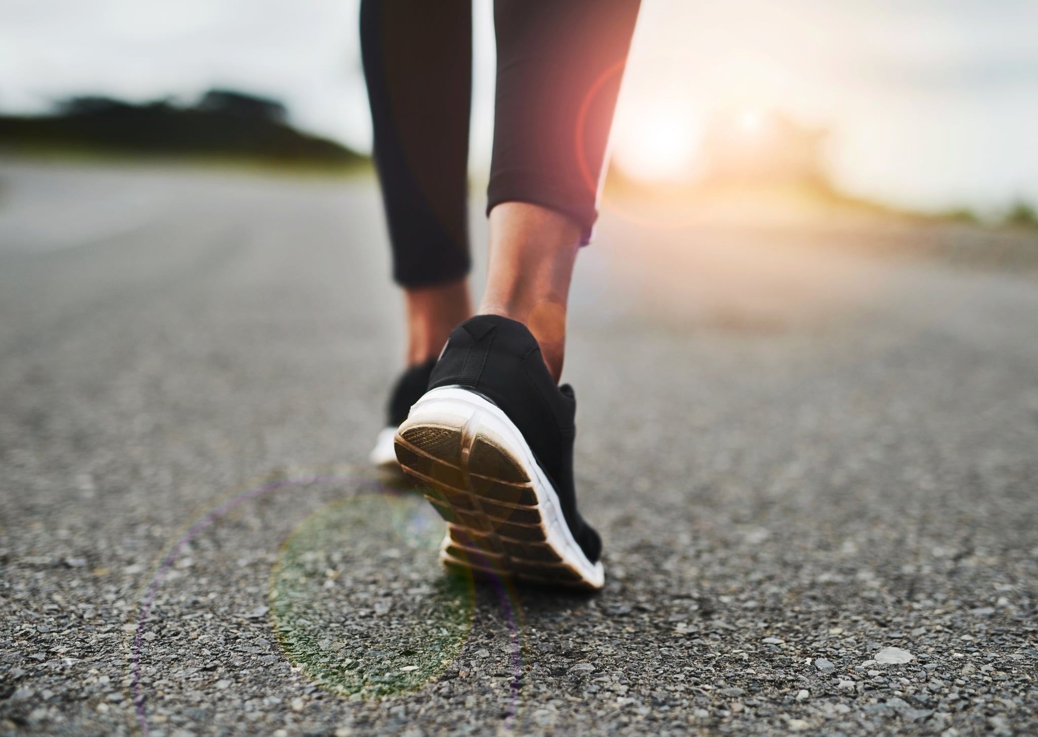 Rearview shot of an unrecognisable young sportswoman's running shoes outside