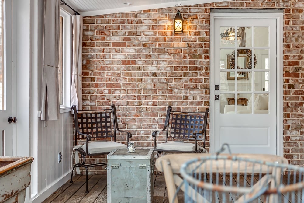 The brick wall on the covered porch adds loads of character.