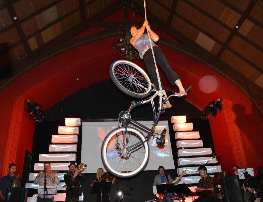 An aerialist performed her magic on a hanging bike.