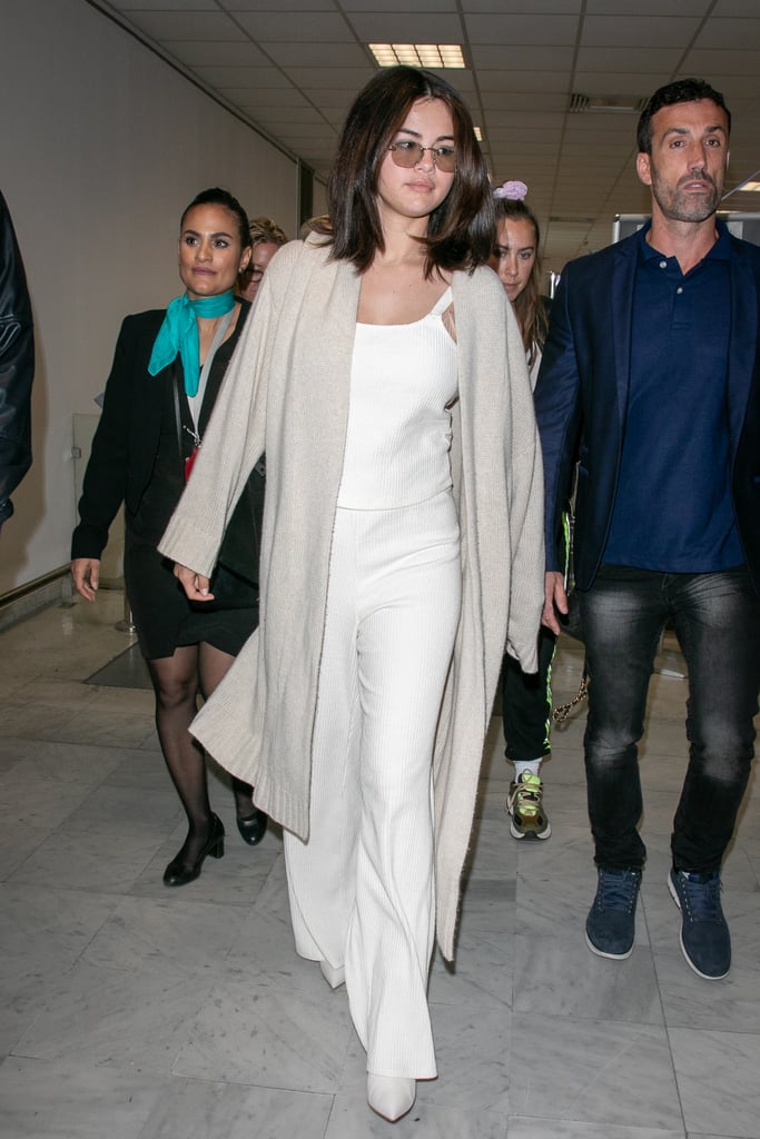 A White Camisole, Pants, and Duster Coat at the Cannes Airport in May 2019