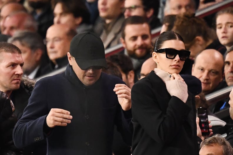 US actor Leonardo Di Caprio (C) and his partner Argentinian and US model Camilla Morrone (R) attend the UEFA Champions League Group C football match between Paris Saint-Germain (PSG) and Liverpool FC at the Parc des Princes stadium, in Paris, on November 